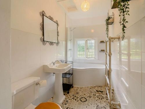 uma casa de banho branca com uma banheira e um lavatório e uma banheira em 2 Bed in Londesborough 88620 em Londesborough