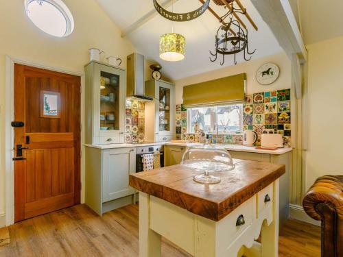 a kitchen with a wooden island in the middle at 1 Bed in Pershore 87365 