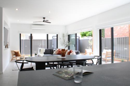 a dining room and living room with a table at The McKinlay Echuca in Echuca