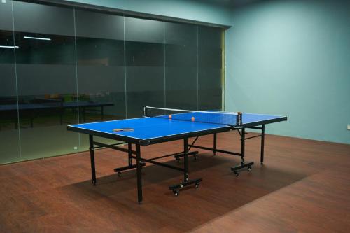 a blue ping pong table in an empty room at Ikshana Resort and Spa, Khandala in Lonavala