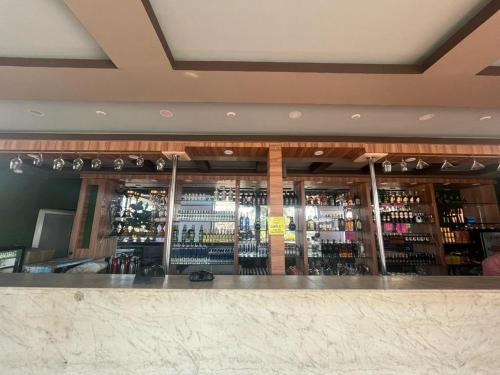 a bar with a lot of bottles of wine at Pokhari Cottage Private Limited in Bahāsi