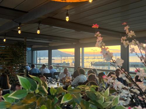 a group of people sitting at tables in a restaurant at P-Hotels Brattøra in Trondheim
