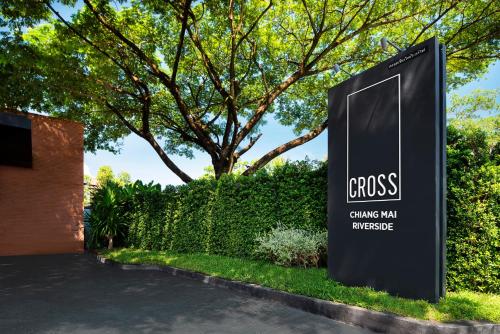a sign for the entrance to a building at Cross Chiang Mai Riverside in Chiang Mai