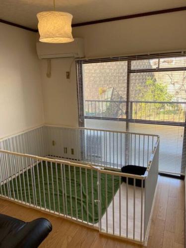 a room with a balcony with a large window at sonic apartment annex 201 4名様まで同一価格 in Dazaifu