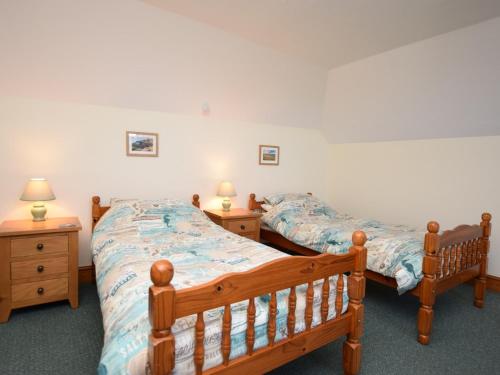 a bedroom with two beds and two night stands at 2 Bed in Bradworthy KANNA in Bradworthy