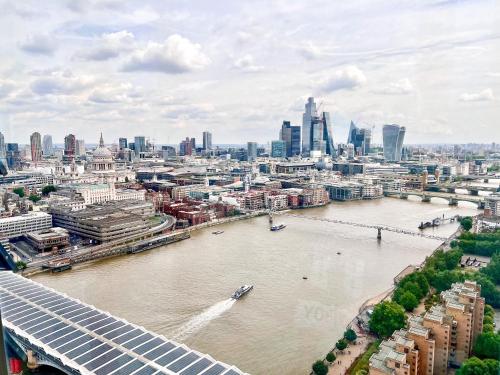 an aerial view of a river with a city at Excellent River Thames View Entire Apartment in London