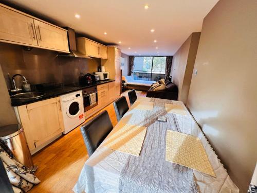a kitchen with a table and chairs in a room at Excellent River Thames View Entire Apartment in London