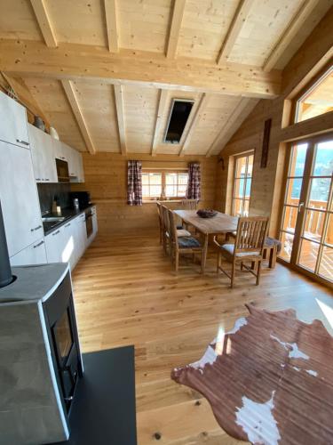a kitchen and dining room with a table in a cabin at Almhütte in Lachtal