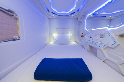 a room with a bed in a hospital room at Passgo Digital Airport Terminal 3 Soekarno Hatta in Tangerang