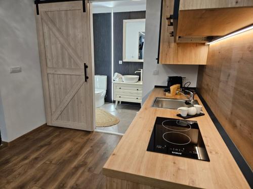 a kitchen with a door open to a bathroom at Malina Glamping in Vama