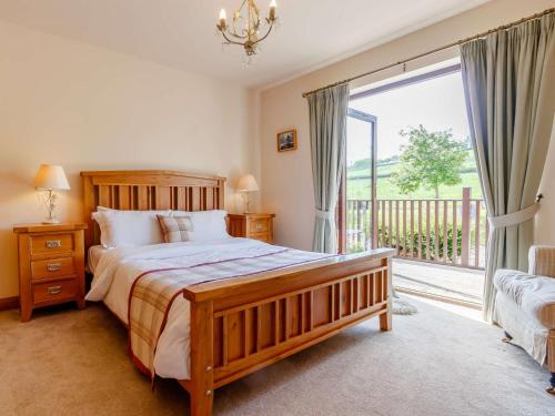 a bedroom with a bed and a large window at 3 Bed in Perth ROWPE in Errol