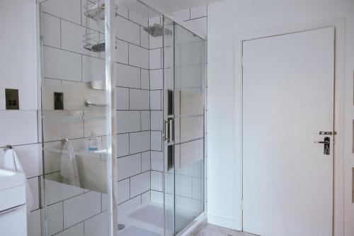 a shower with a glass door in a bathroom at COZY PLACE LIVERPOOL in Liverpool