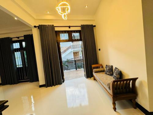 a living room with a couch and a window at Royal Palace Mirissa in Mirissa