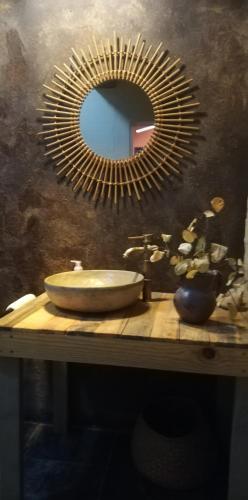 a bathroom with a sink and a mirror on a table at AshTree GuestHouse in Hanover