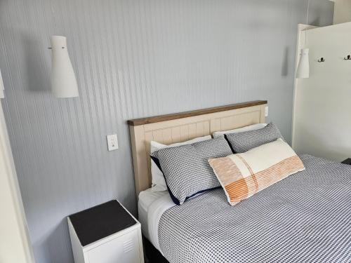 a bedroom with a bed with two pillows on it at Inner city base in Nelson