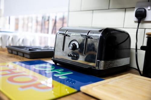 a black toaster sitting on top of a counter at COZY PLACE LIVERPOOL in Liverpool