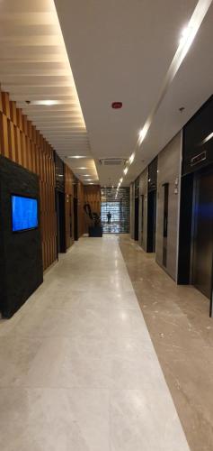 an empty hallway in a building with a tv on the wall at C Place - Capsule A in Manila