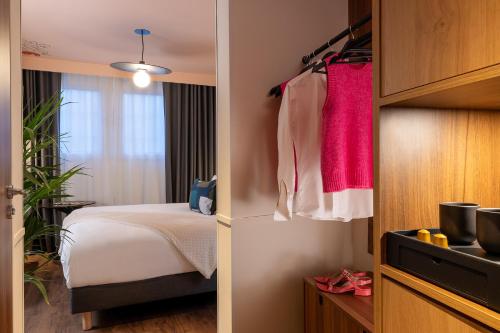 a bedroom with a bed and a room with a window at Les Artistes in Paris
