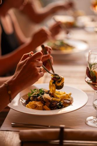 a person eating a plate of food on a table at Insel der Sinne in Görlitz