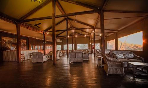 a room with chairs and tables in a tent at Nkambeni Safari Camp in Hazyview