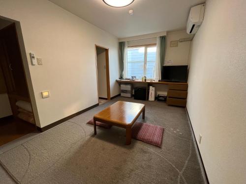 a living room with a table in a room at LiVEMAX RESORT Shiretoko Sea Front in Rausu