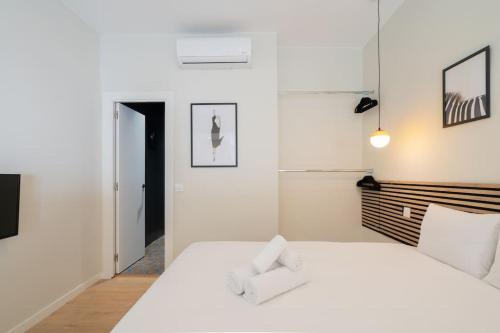 a white bedroom with a large white bed with white pillows at Nice studio in Madrid-Fp02 in Madrid