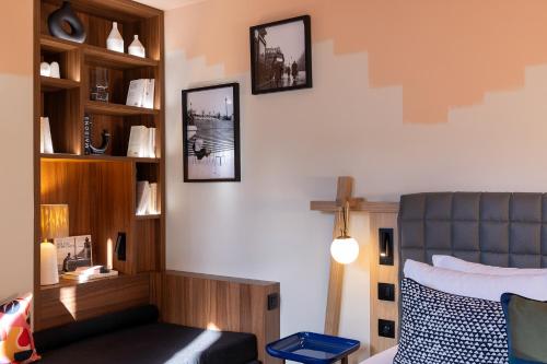 a bedroom with a bed and a cross on the wall at Les Artistes in Paris