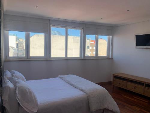 Кровать или кровати в номере Apartamento vistas Coruña 3 habitaciones