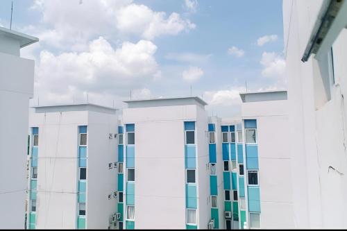 a row of white buildings against a cloudy sky at Barata Residence Aeropolis in Tangerang