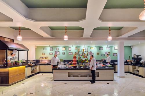 a group of chefs preparing food in a kitchen at Sterling Mount Abu in Mount Ābu