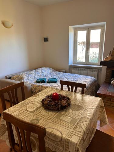 a room with a table and a bed with a bowl on it at HAPPY HOME in Orte