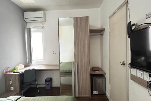 a bedroom with a mirror and a desk and a bed at Barata Residence Aeropolis in Tangerang