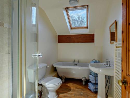 a bathroom with a tub and a toilet and a sink at 5 Bed in Blackpool 40993 in Pilling