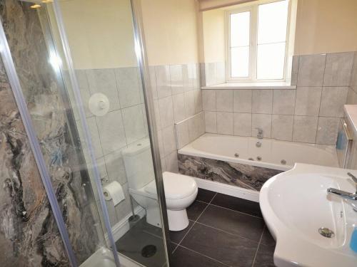 a bathroom with a toilet and a sink and a shower at 1 Bed in Barnstaple 40352 in Chapelton