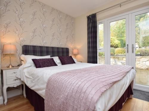 a bedroom with a bed and a window at 2 Bed in Edinburgh 42778 in Roslin