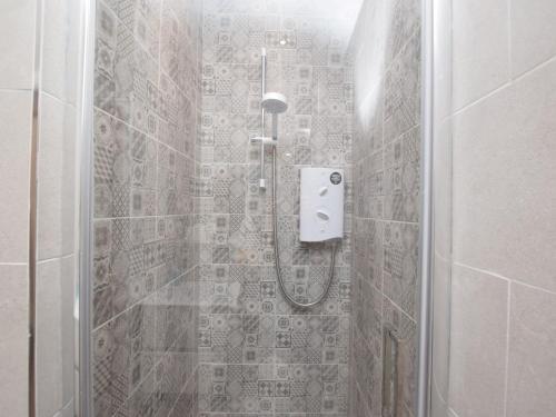 a bathroom with a shower with a glass door at 2 Bed in Ashford in the Water PK502 in Great Longstone