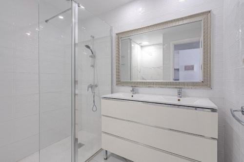 a white bathroom with a sink and a mirror at CLUB PARAISO 1a085 in Playa Paraiso