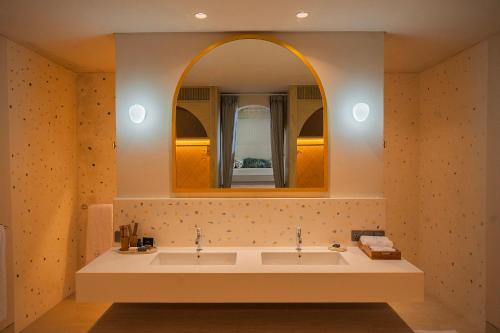 a bathroom with a sink and a mirror at Poco Poco villas by Aayan in Jimbaran