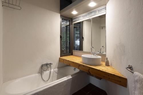 a bathroom with a sink and a mirror at Blue Ivy Pool Villa #FeelsLikeHome in Vourvourou