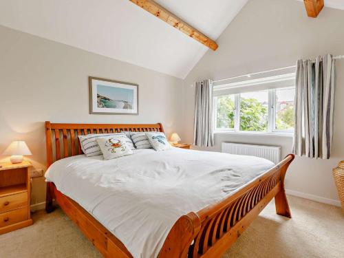 a bedroom with a large bed and a window at 4 Bed in Bude 50591 in Bude