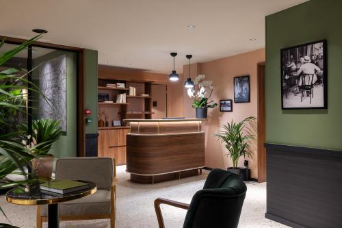 a living room with a couch and a table at Les Artistes in Paris