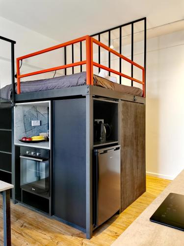 a bunk bed in a room with a kitchen at Unique City Centre Apartments in Nicosia