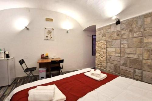 a bedroom with a bed with two towels on it at [Sea Front] - Welcoming Room in Mergellina in Naples