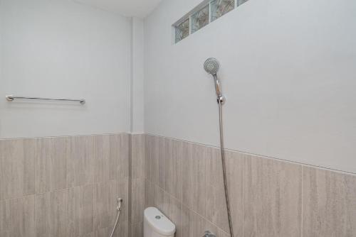 a shower in a bathroom with a toilet at RedDoorz Syariah near Batu Night Spectacular in Malang