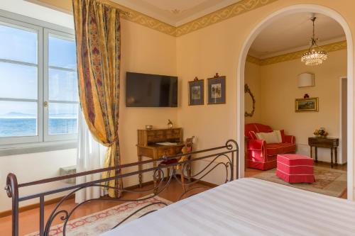 a bedroom with a bed and a large window at Hotel Villa Marsili in Cortona