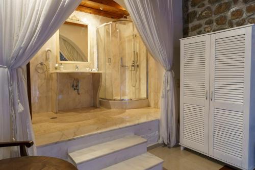 a bathroom with a shower and a sink at Nereids Guesthouse in Hydra