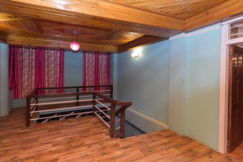 a room with a bunk bed and a wooden ceiling at OYO Flagship Balaji Guest House in Shillong