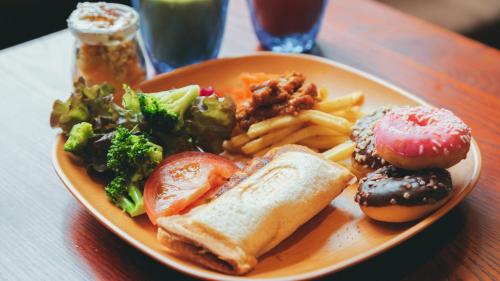 a plate of food on a wooden table at QuintessaHotel KagoshimaTenmonkan Relax&Sleep in Kagoshima