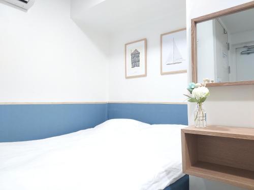 a bedroom with a bed and a mirror at One Minute Guesthouse in Seoul