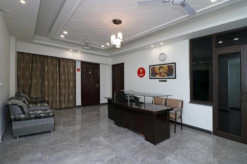 an office with a desk and a chair in a room at Jagat Residency in Rājpur